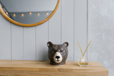 Home decoration, huge and aromatherapy concept-aromatic reed diffuser and souvenir bear head 