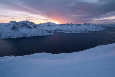 Scenic view of snowcapped mountains against sky during sunset