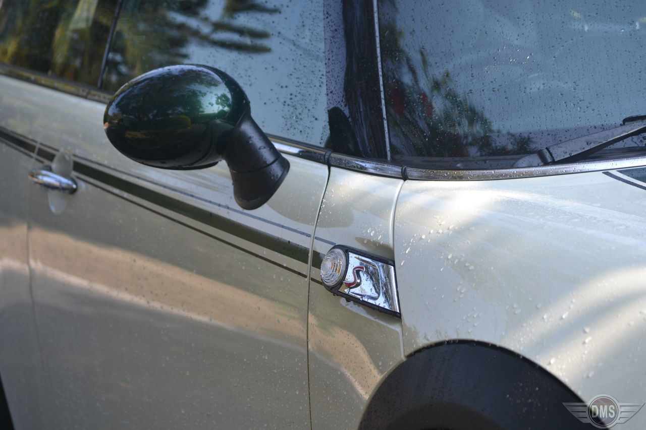 CLOSE-UP OF VINTAGE CAR ON SIDE-VIEW MIRROR OF VEHICLE