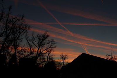 Silhouette trees against sky at sunset