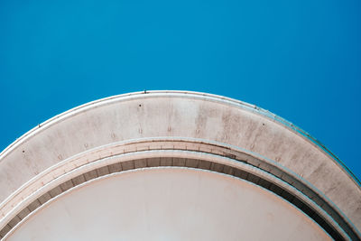 Low angle view of storage tank against clear blue sky