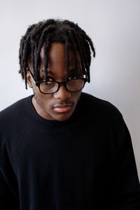 Young black man student wearing glasses