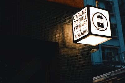 Low angle view of road sign at night
