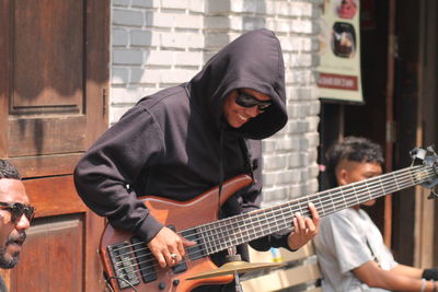 Man playing guitar at  side walk music concert