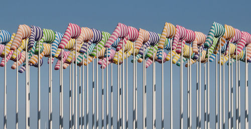 Low angle view of colorful windsocks against clear sky