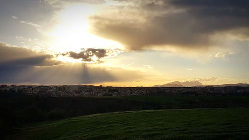 Scenic view of field against sky during sunset