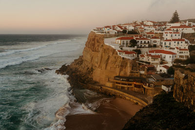 Scenic view of sea in azenhas do mar against sky during sunset