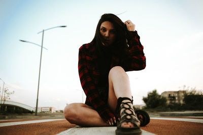 Full length of fashionable young woman on zebra crossing in city