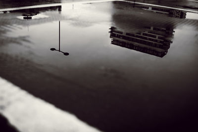 Reflection of building in puddle