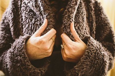 Midsection of woman standing outdoors during winter