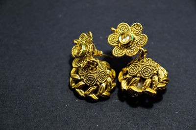 High angle view of gold colored pencils on black background