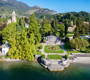 High angle view of trees and buildings by lake