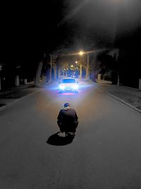 Man on illuminated street at night