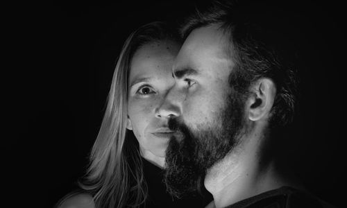 Portrait of man and woman on black background