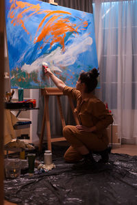 Woman painting at home