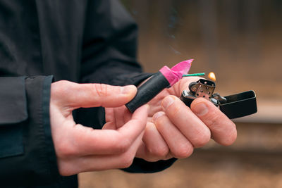 Midsection of woman holding fire