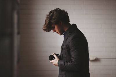 Side view of a man using mobile phone