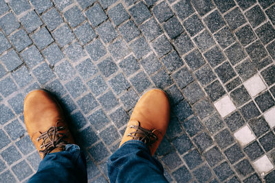 Low section of man standing on footpath