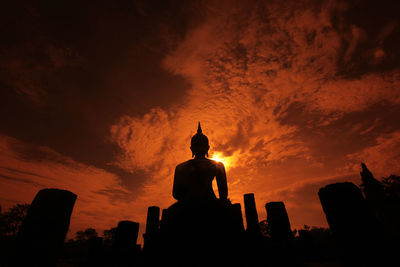 Low angle view of silhouette statue against sky during sunset