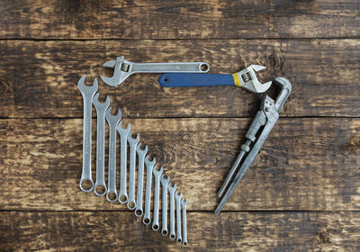 Directly above shot of wrenches on wooden table