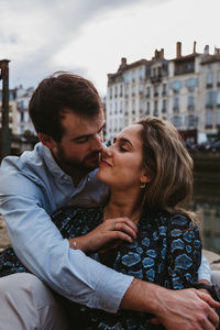 Man and woman with city in background