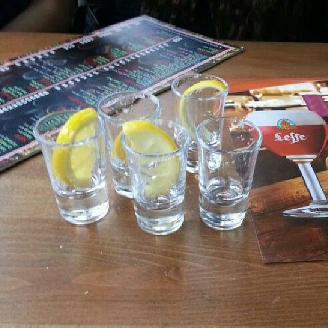 food and drink, drink, table, drinking glass, freshness, refreshment, indoors, still life, glass - material, alcohol, restaurant, drinking straw, close-up, glass, transparent, focus on foreground, wood - material, cocktail, no people, juice