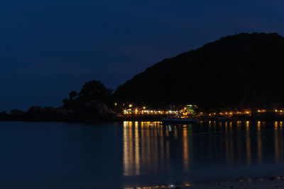 Scenic view of illuminated mountains against sky at night