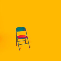 Chairs against yellow background