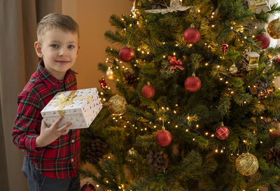 Cute girl decorating christmas tree