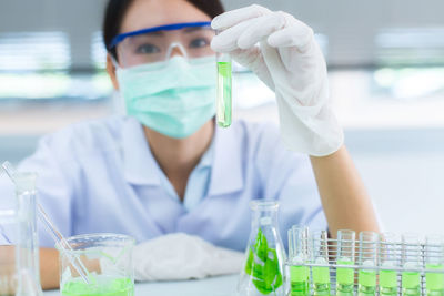 Close-up of female scientist experimenting in laboratory