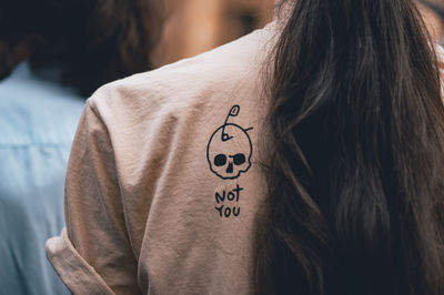 Rear view of woman with text