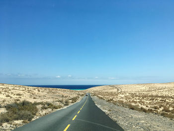 Fuerteventura road leading towards blue sky