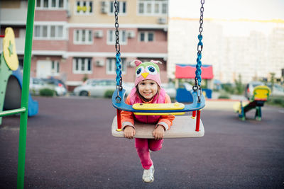 Full length of boy swinging at playground