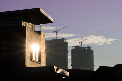 Low angle view of silhouette buildings against sky