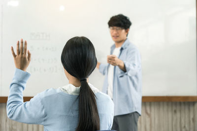 Rear view of a man standing with text