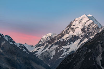 Scenic view of snowcapped mountains against sky during sunset