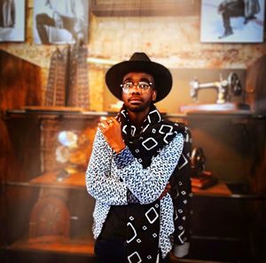 Portrait of young man standing at home