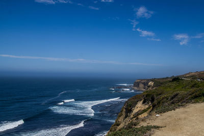 Scenic view of sea against blue sky