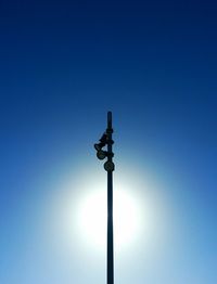 Low angle view of street light against clear blue sky