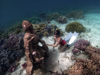 High angle view of woman swimming in sea