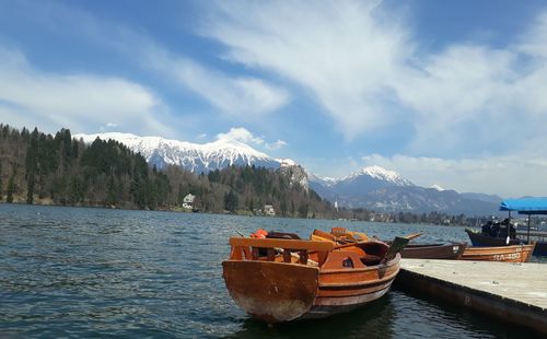 Boats moored on sea against sky