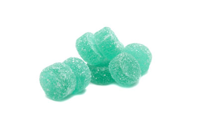 Close-up of green candies against white background