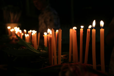 Close-up of burning candles in temple