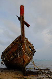 Abandoned boat at coastline