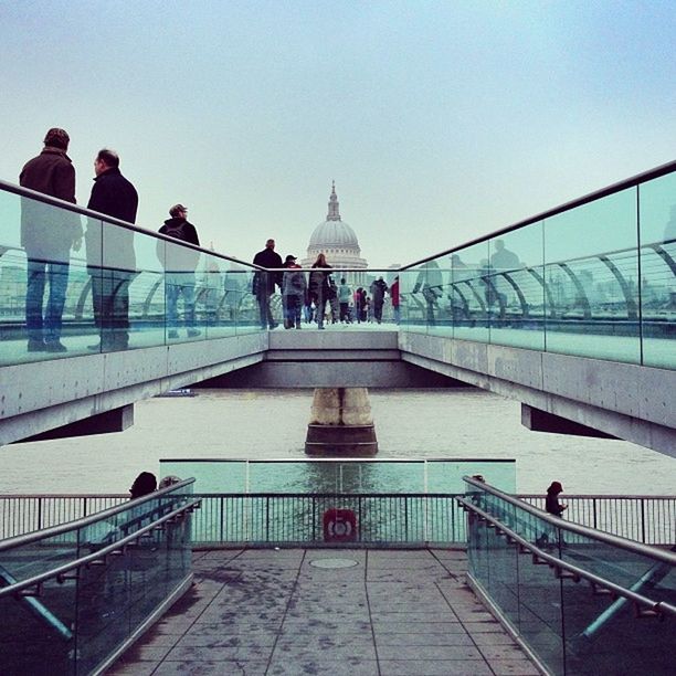 architecture, built structure, railing, clear sky, men, person, building exterior, walking, lifestyles, bridge - man made structure, travel destinations, rear view, steps, tourism, travel, leisure activity, water, copy space, connection