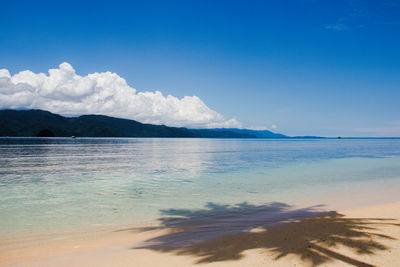 Scenic view of sea against blue sky