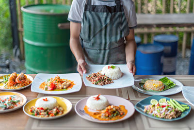 Midsection of man preparing food on table