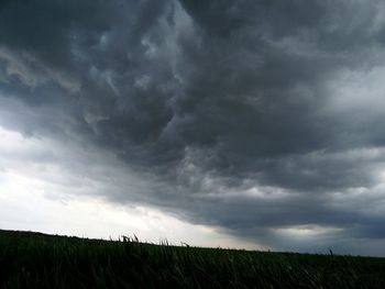 Scenic view of dramatic sky over field