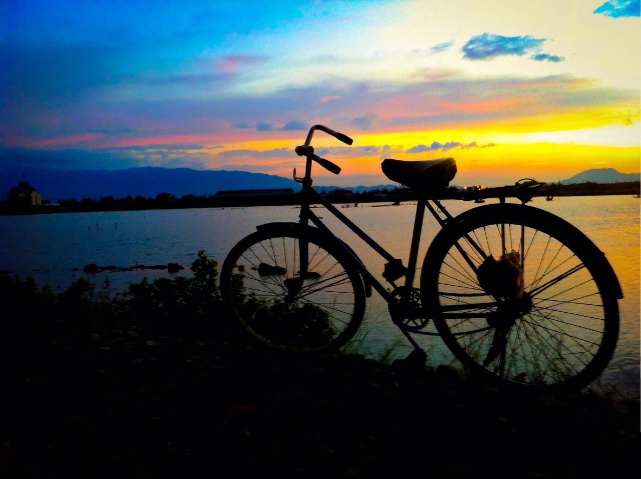 sunset, bicycle, sky, transportation, mode of transport, cloud - sky, silhouette, orange color, tranquility, land vehicle, tranquil scene, stationary, scenics, beauty in nature, water, parking, cloud, nature, lake, outdoors