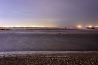 Scenic view of beach against sky at night